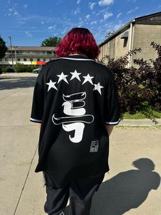 Counting Stars ⭐️⭐️⭐️⭐️⭐️ Stray Kids 5-Star themed black jersey. S-Class who? This black jersey is centered around the 5 Star album cover with Stray Kids logo on the sleeve. Perfect for concerts, street outfit, or learning choreo. * Logo on the sleeve is optional. Please leave a note as a personalization if you do not want it. ** Do you have a bias? Don't be shy leave a note! 🤭  If you don't or if this is a gift and you don't know it's okay this does not affect production. Casual Black T-shirt With Star Print, Black Letter Print Baseball Jersey For College, College Black Baseball Jersey With Letter Print, Black College Baseball Jersey With Letter Print, Black Sporty Baseball Jersey With Letter Print, Black Baseball Jersey With Graphic Print For College, Black Baseball Jersey With Graphic Print For Sports Season, Black Short Sleeve College Baseball Jersey, Black Short Sleeve Baseball Jersey For College