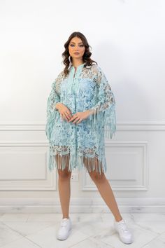 (SALE ITEM - FINAL SALE)Featuring: Floral Lace Fringe sleeves Unlined Bell sleeves Band collar Color: Tiffany blue.Brand: Unmatched BYU.Match it with a slip dress - The model is wearing a baby blue mini slip dress (Shop slip dresses)Size: Free Size. "fits sizes between 2 (US) up to 24 (US)"Exact Caftan Measurements: Bust: 52 (Inches)Hem: 63 (Inches)Length: 32.5 (Inches)This caftan is available in multiple colors Elegant Spring Kaftan For Beach Cover-up, Spring Beach Cover-up Dress With Tassels, Sheer Light Blue Dress, Spring Party Midi Dress With Kimono Sleeves, Summer Wedding Long Sleeve Kaftan, Elegant Long Sleeve Dress For Beach Cover-up, Fitted Long Sleeve Spring Kaftan, Long Sleeve Tassel Dress For Beach, Spring Party Dress With Kimono Sleeves