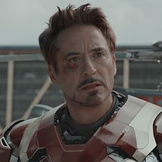 the iron man is looking at something in front of him with an angry look on his face