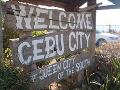 a wooden sign that says welcome to ceruciaty and queen city south of the south