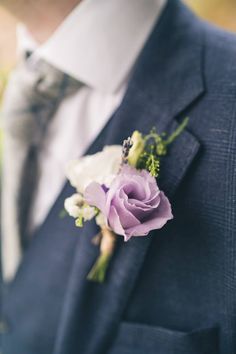 a man in a suit with a boutonniere on his lapel