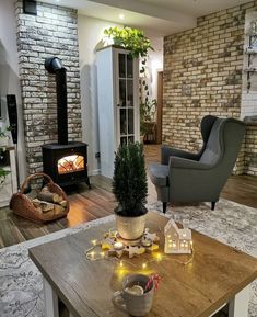 a living room filled with furniture and a fire place in the middle of it's wall