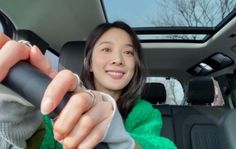 a woman is sitting in the back seat of a car