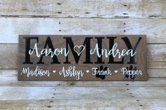 a wooden sign that says family with hearts and the words, made in black ink