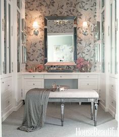 a bathroom with a bench, mirror and lights on the wall next to the sink