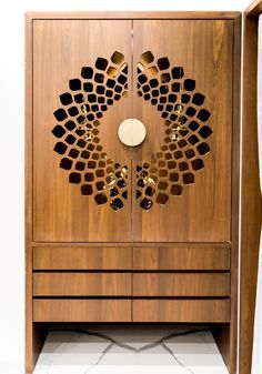 a wooden cabinet with an intricate design on it