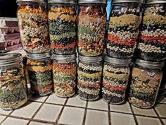 several jars filled with different types of food on a counter top next to each other