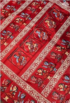 an old red cloth with colorful designs on it