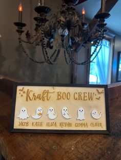 a wooden sign that says, kraut boo crew with ghost faces on it