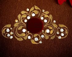 a red and white flower sitting on top of a brown table