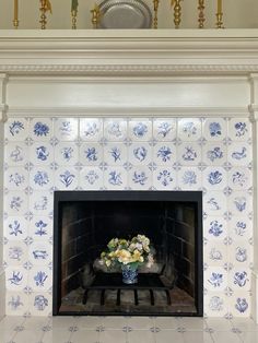 the fireplace is decorated with blue and white tiles