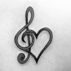 a heart with a treble tattoo on it