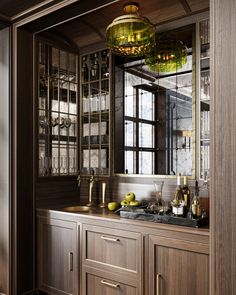 a kitchen area with wooden cabinets and glass front cupboards, gold accents on the doors