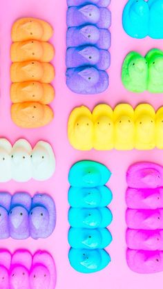 several different types of doughnuts on a pink background