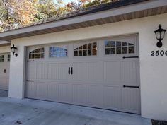 a garage with two doors and windows on the side