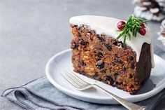 a piece of cake on a white plate with a fork and napkin next to it