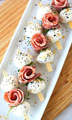 an appetizer is arranged on a plate with toothpicks