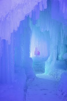 an ice cave with snow and icicles on the walls