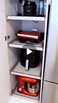 an image of a kitchen cupboard with appliances in the door and shelves on the wall