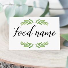 a card with the word food name on it next to some leaves and greenery