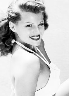 a black and white photo of a woman smiling