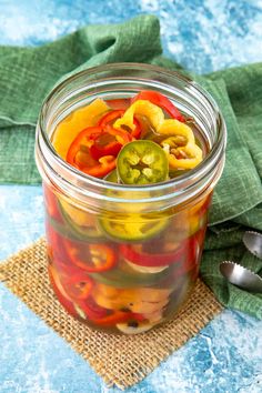 a glass jar filled with pickles and peppers