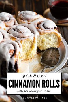 a cinnamon roll on a plate with a bite taken out of it and the words quick & easy cinnamon rolls