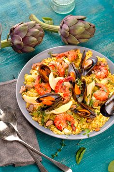 a plate of food with mussels and clams in it on a table