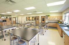 an empty classroom with desks and chairs in it's center area is shown