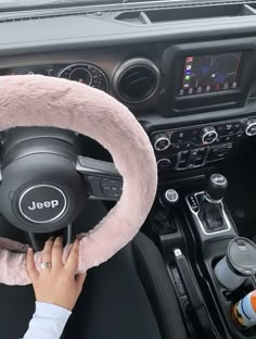 a person driving a car with a steering wheel cover