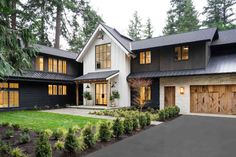 a large black and white house with lots of windows