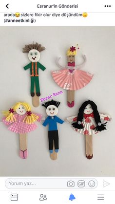 paper dolls made to look like children's clothes and hair are on the stick