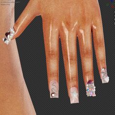 a woman's hand with white and pink nail designs on it, next to her wrist