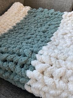 a crocheted blanket sitting on top of a couch