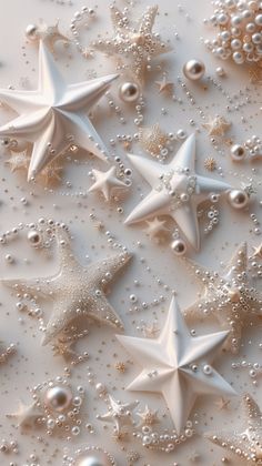 some white stars and pearls on a table