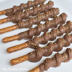 chocolate covered pretzels are lined up on a plate