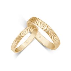 two yellow gold wedding bands with an intricate design on each band, set against a white background