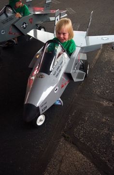 a little boy sitting in a toy airplane