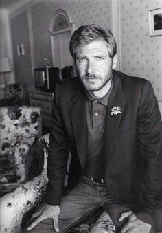 black and white photograph of a man sitting on a couch