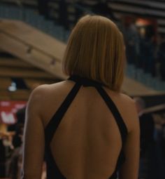 the back of a woman in a black dress