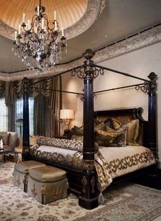 a fancy bedroom with four poster bed and chandelier