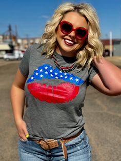 Grey Patriotic Lips Graphic Tee by Texas True Threads Ultra soft Bella Canvas tee True to size fit, or size down for a slimmer fit Fitted Flag Print Short Sleeve Tops, Fitted Patriotic Cotton Top, Fun Crew Neck T-shirt With American Flag Print, Fun American Flag Print Crew Neck T-shirt, Fitted Patriotic Short Sleeve Tops, Fun American Flag Print T-shirt Crew Neck, Fitted Cotton Patriotic Tops, Fitted American Flag Print Cotton Tops, Fitted Cotton Tops With Flag Print