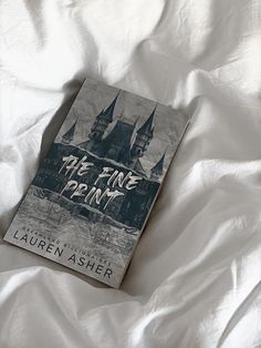 a book sitting on top of a bed covered in white sheets with writing that reads, the fire department