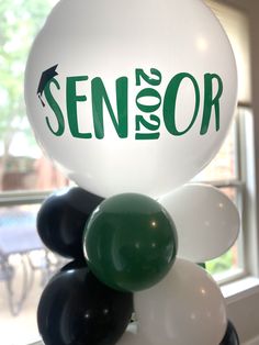 balloons are stacked on top of each other with the word senior in green and white