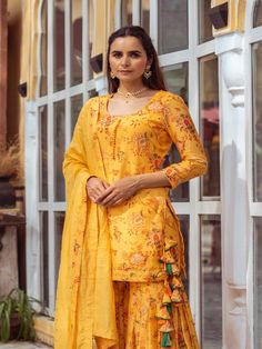 This Set Has Kurta, Gharara & Dupatta. Gorgeous combination of yellow, printed kurta gharara with potli buttons and intricate detailing with matching Chanderi foil print dupatta. Color: Yellow Fabric: Kurta & Gharara- Cotton Silk Dupatta - Chanderi Product Details: Neck Type - Round neck Anarkali Length - 34 inches Bottom Length - 38-40 inches Sleeve Length - 18-19 inches Note: Available in other colors The product will be delivered within 2-4 weeks of order placed Wash Care - Dry clean only Mea Yellow Anarkali Palazzo Set With Printed Motifs, Yellow Palazzo Set With Printed Motifs In Traditional Drape, Yellow Chanderi Sharara With Printed Motifs, Yellow Palazzo Set With Printed Motifs And Traditional Drape, Traditional Yellow Palazzo Set With Printed Motifs, Anarkali Sets With Printed Motifs In Yellow, Chanderi Sharara With Printed Motifs For Festivals, Festive Chanderi Sharara With Printed Motifs, Transitional Chanderi Sharara With Printed Motifs