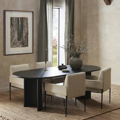 a dining room table with four chairs and a vase on top of it in front of a window