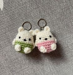 two crocheted keychains with teddy bears on them sitting next to each other