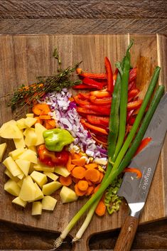 chopped up vegetables on a cutting board with a knife