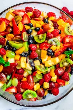 a glass bowl filled with mixed fruit salad