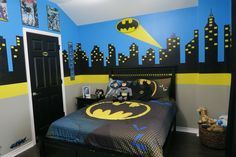 a batman themed bedroom with blue and yellow walls